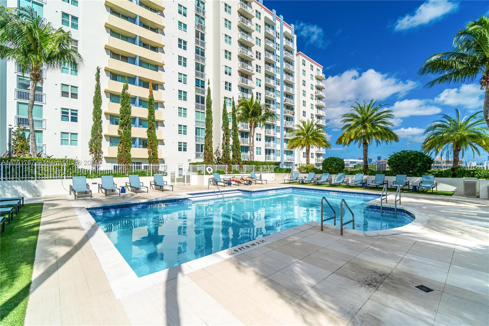 a view of swimming pool with outdoor seating and plants