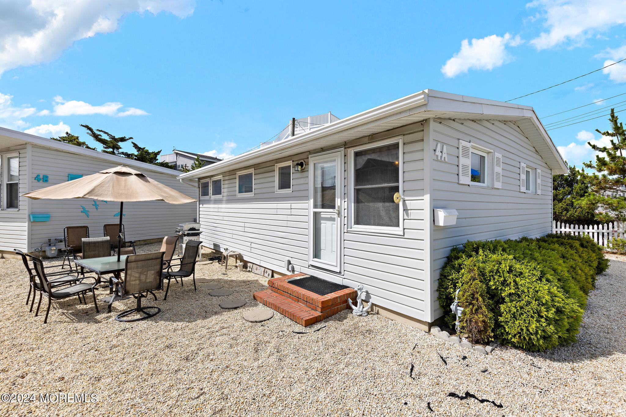 a backyard of a house with yard barbeque oven and outdoor seating