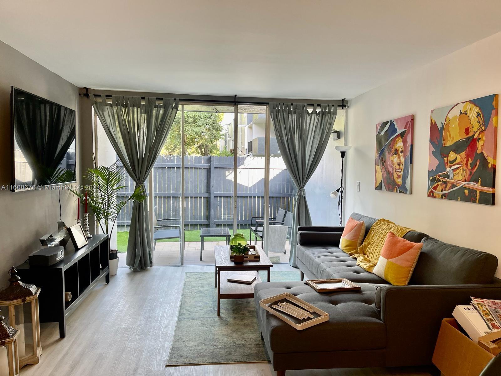 a living room with furniture fireplace and a large window