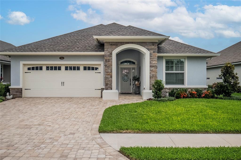 a front view of a house with a yard and garage