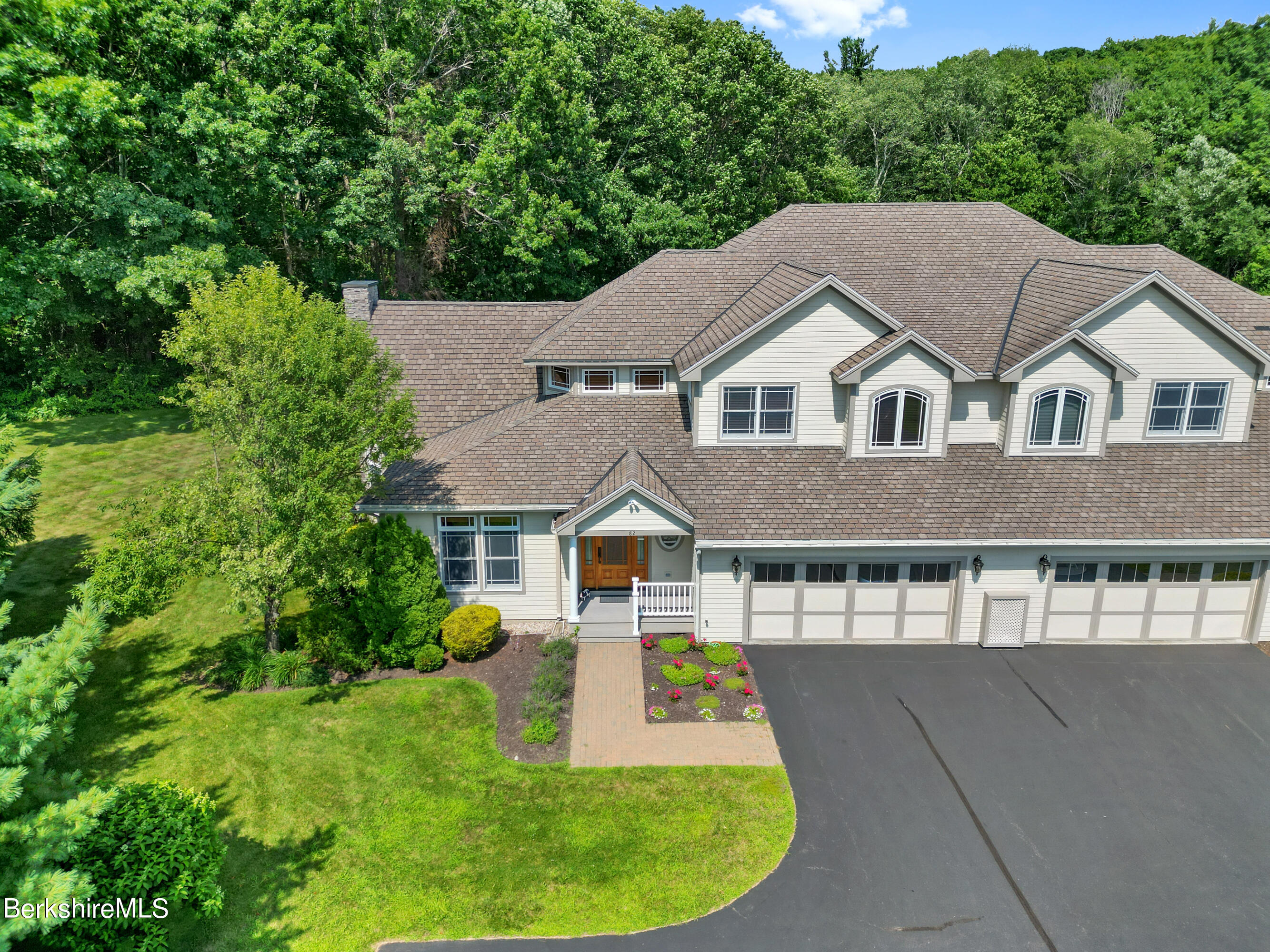 a aerial view of a house with a yard and potted plants