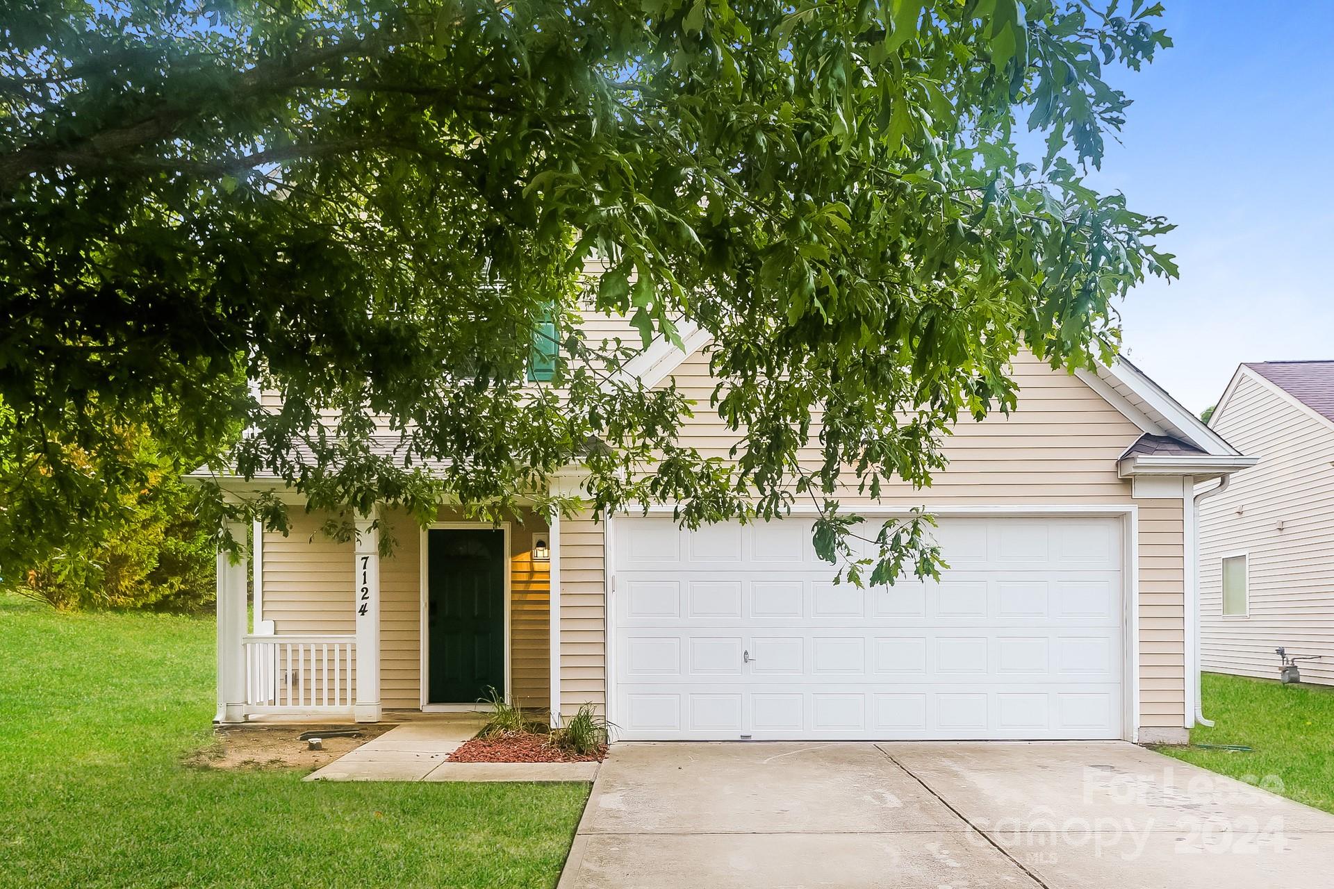 front view of a house with a tree