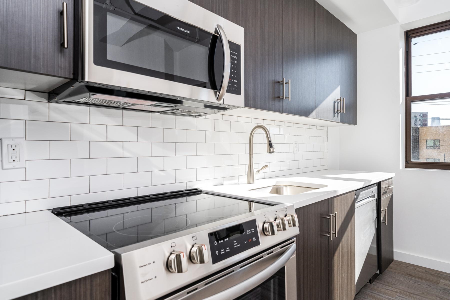 a kitchen with a stove microwave and sink