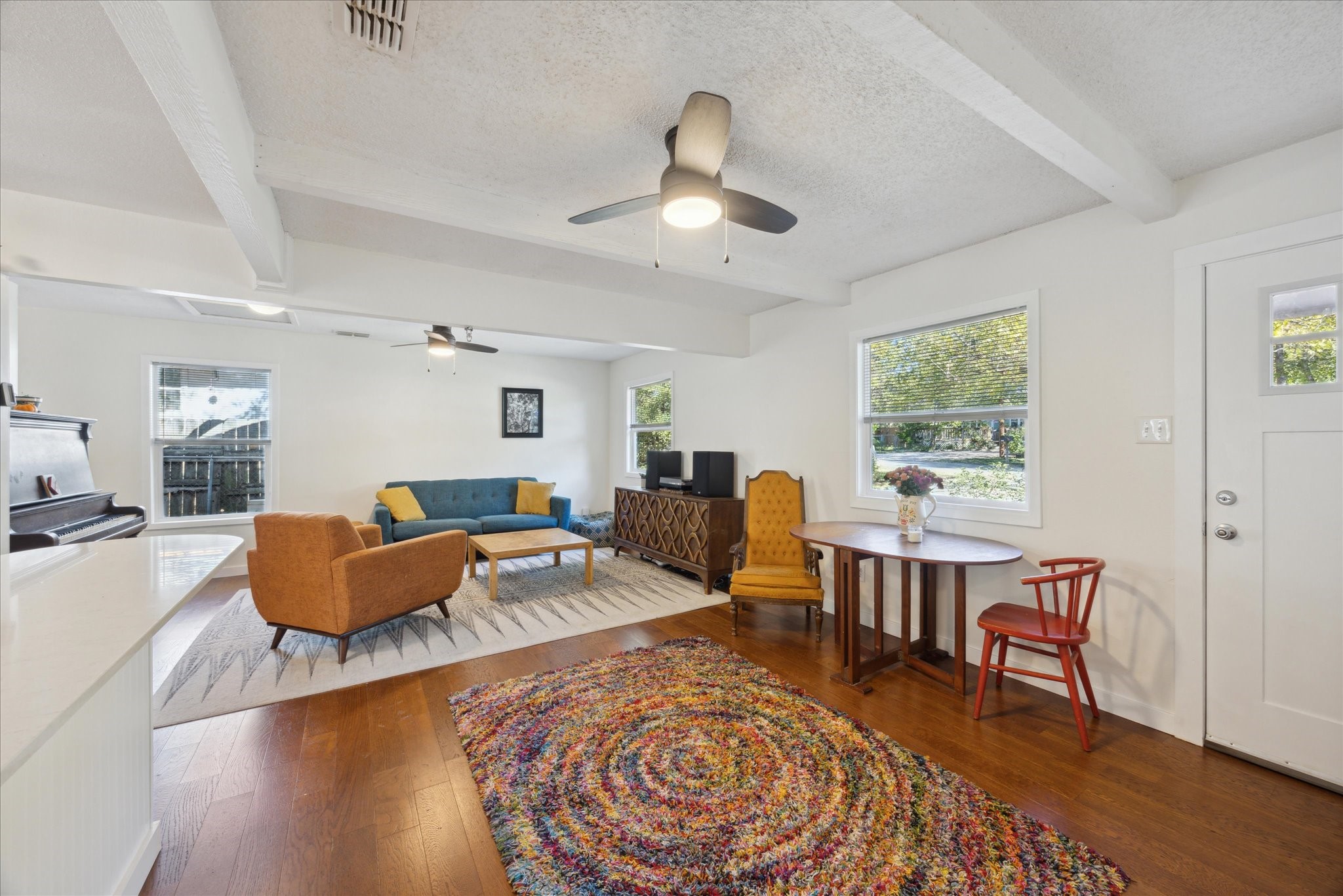 a living room with furniture and a wooden floor