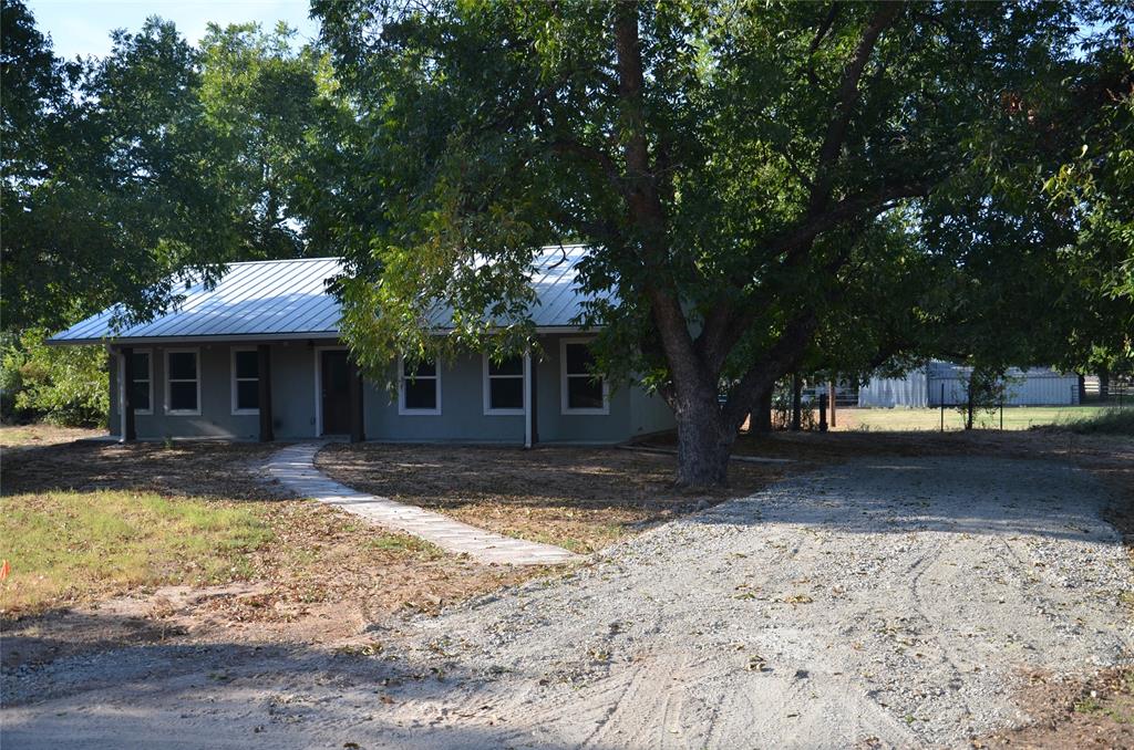 a front view of a house with a yard and balcony