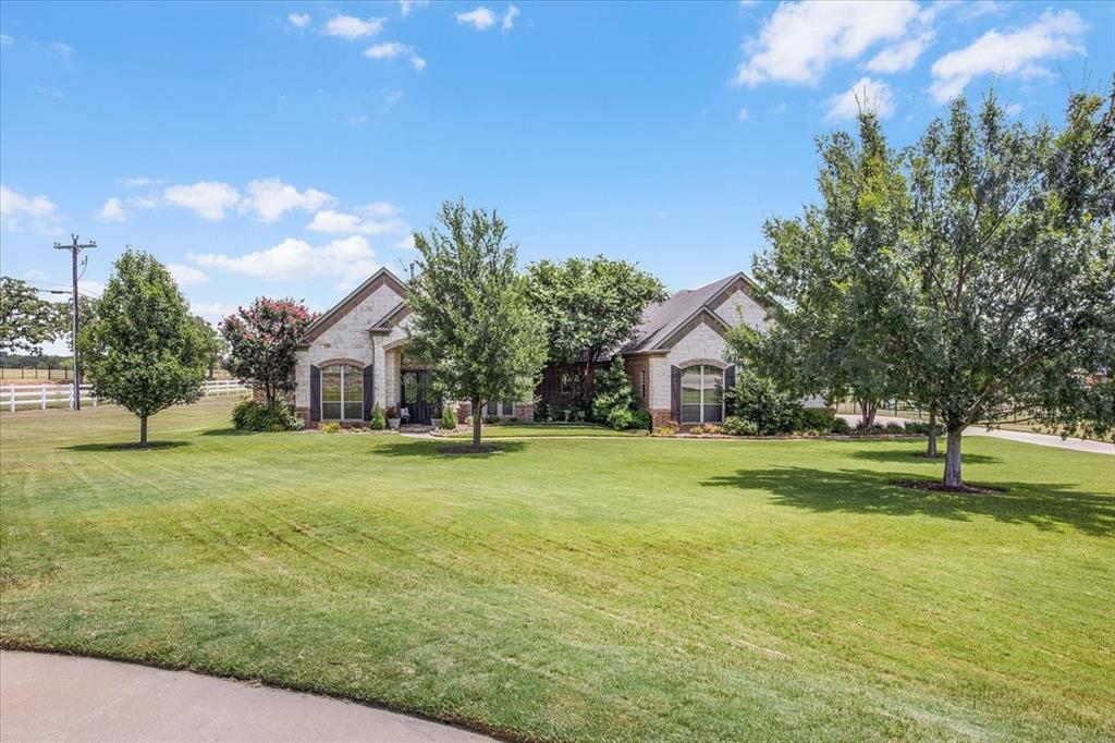 a front view of a house with a big yard