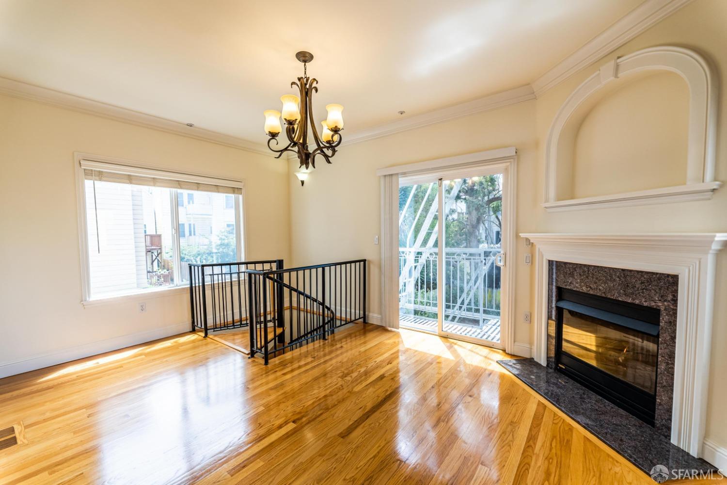 a view of an empty room with a fireplace and a window