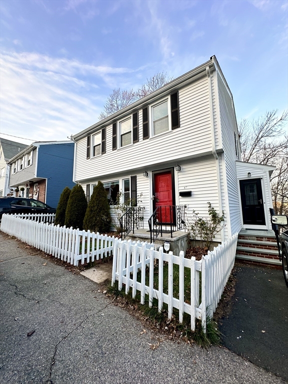 a front view of house with deck yard and furniture