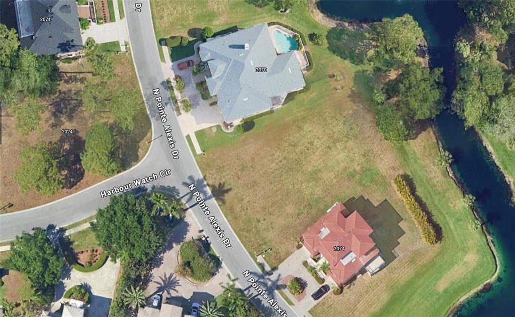 an aerial view of a house with a yard