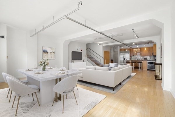 a living room with furniture and view of kitchen