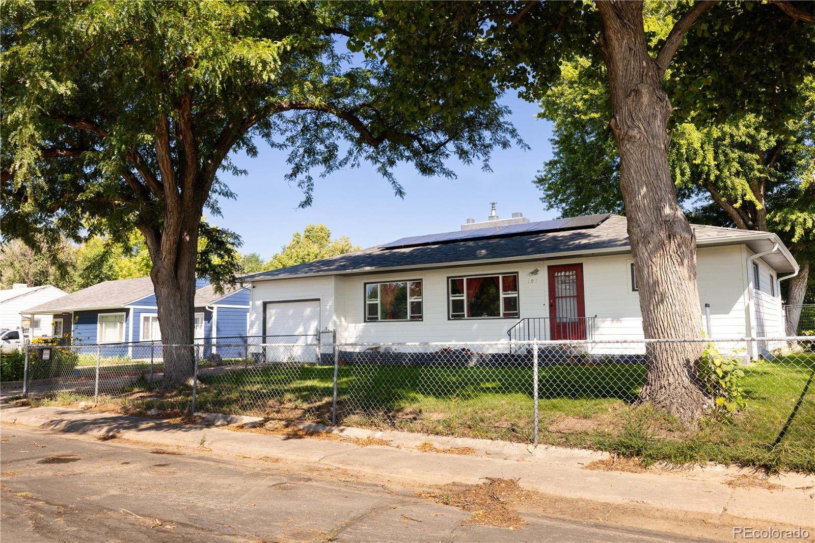 front view of a house with a tree