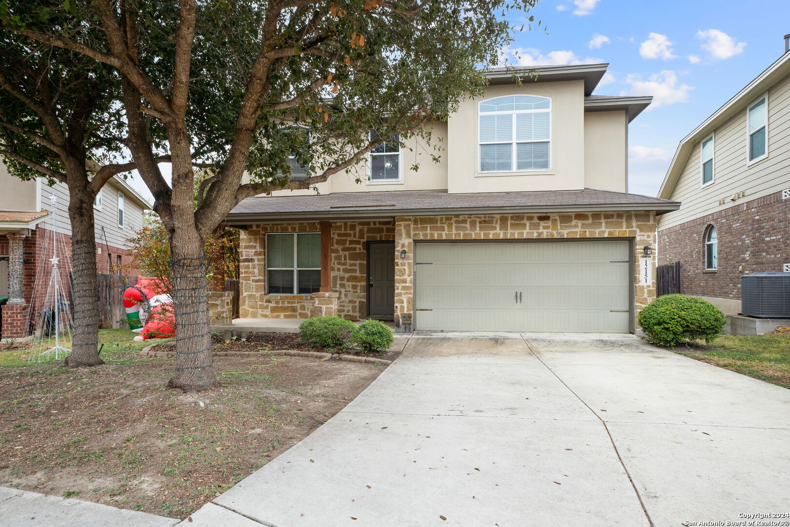 a front view of a house with a yard and garage