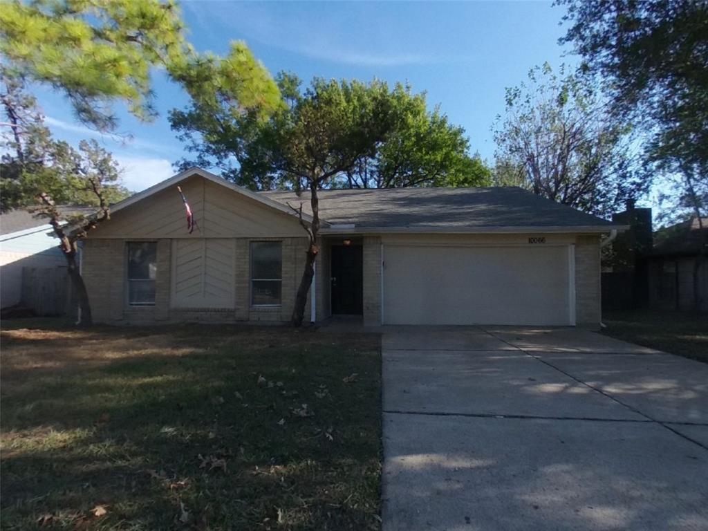 a house that has a tree in front of it