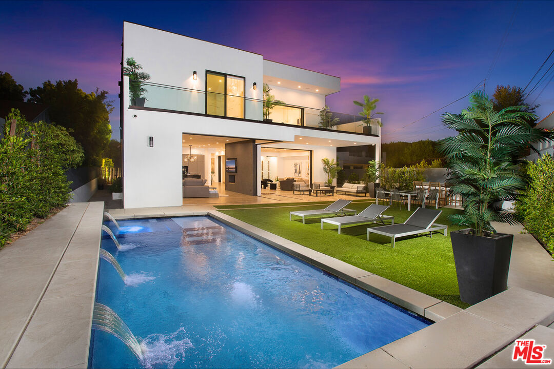 a view of a house with swimming pool yard and sitting area