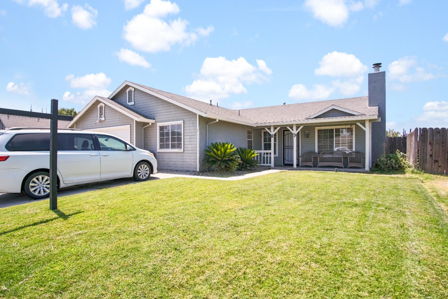 a front view of a house with a garden and yard