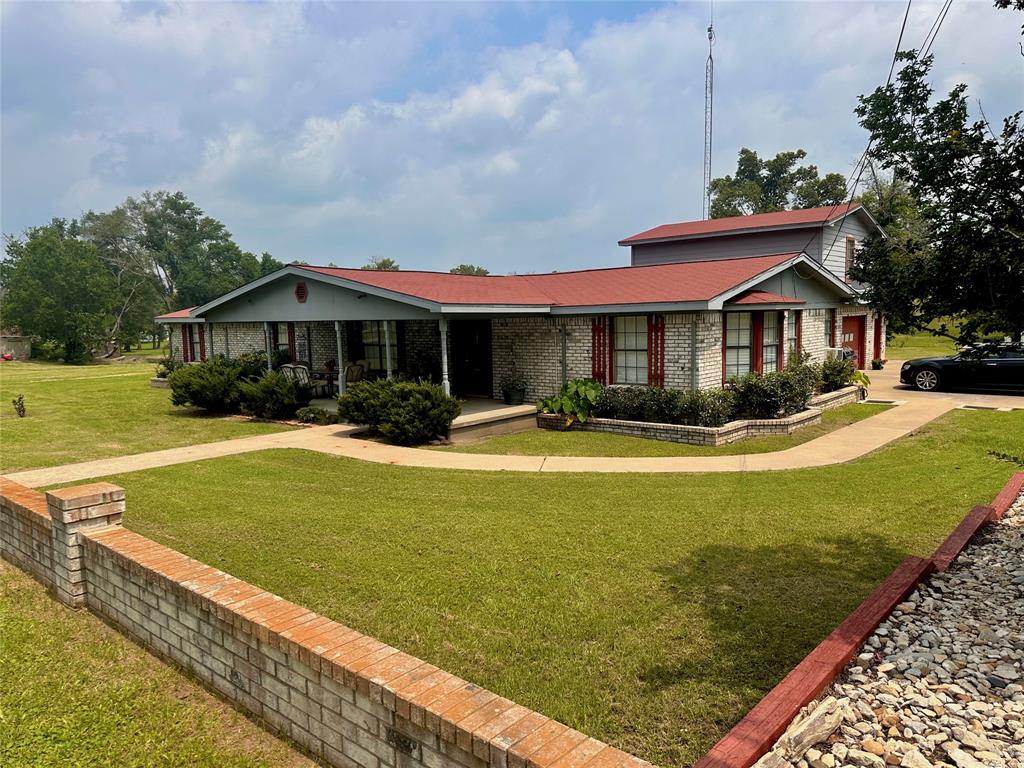 a front view of a house with swimming pool having outdoor seating