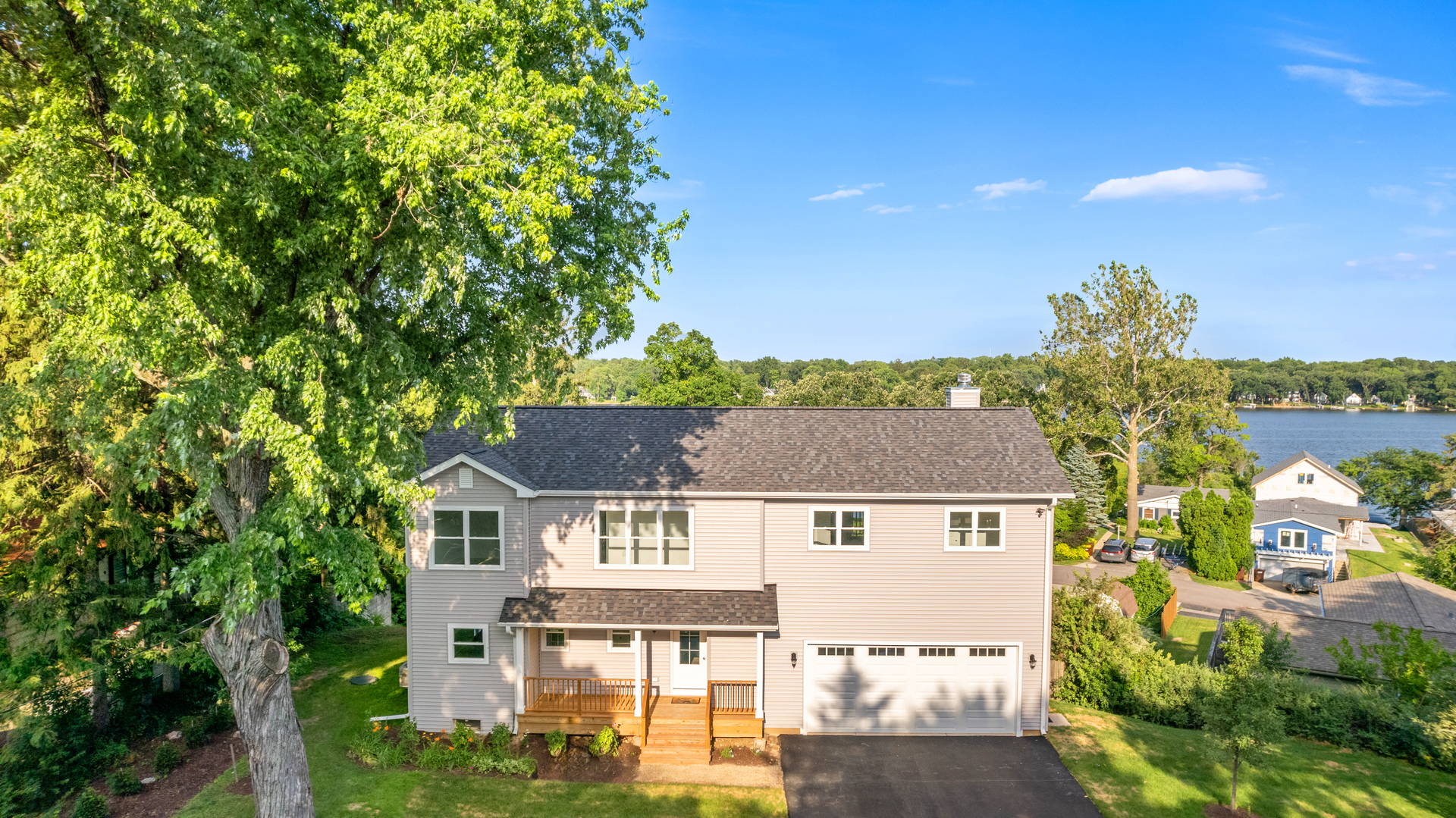 an aerial view of residential houses with outdoor space and street view