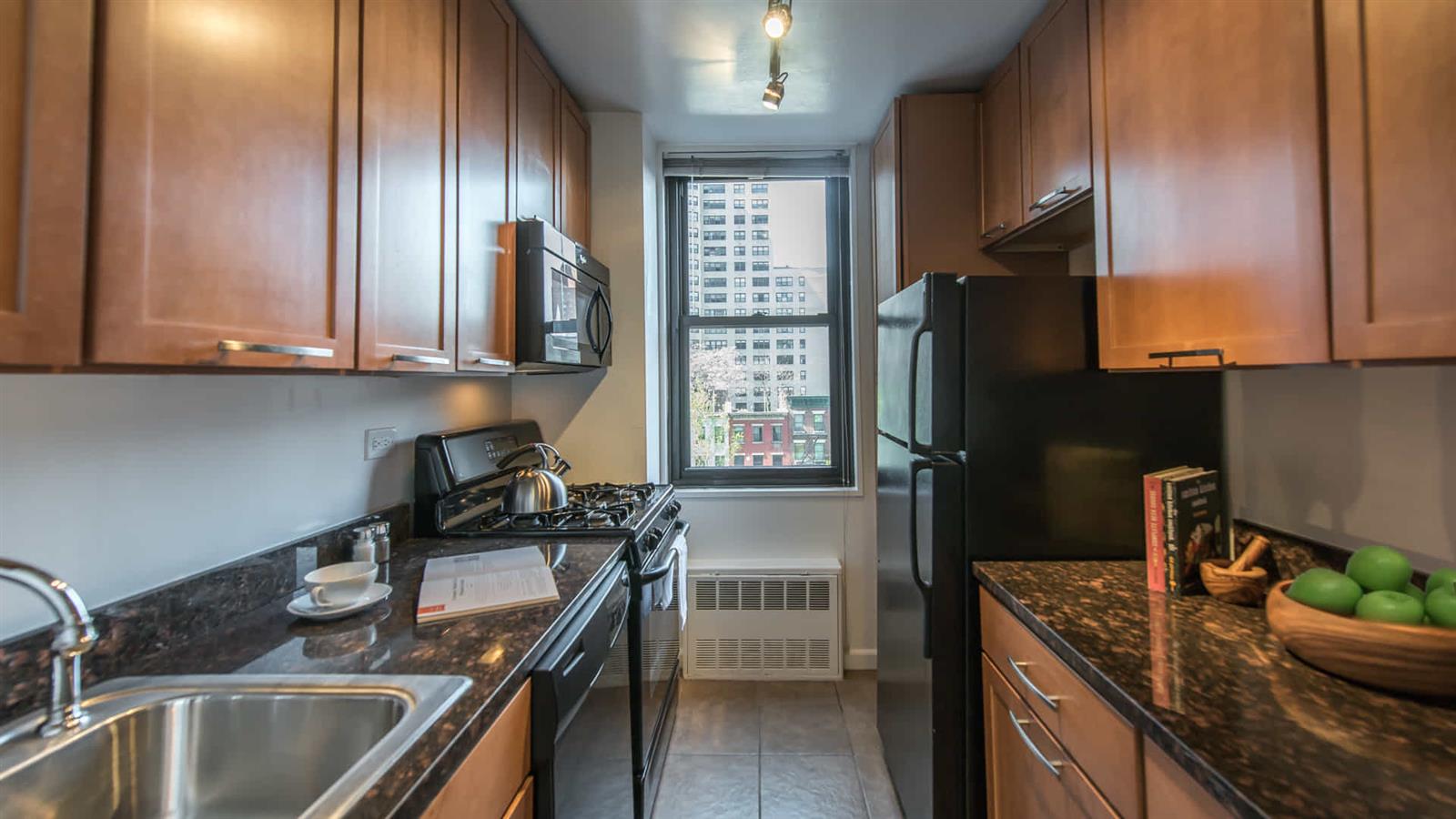 a kitchen with stainless steel appliances granite countertop a sink stove and refrigerator