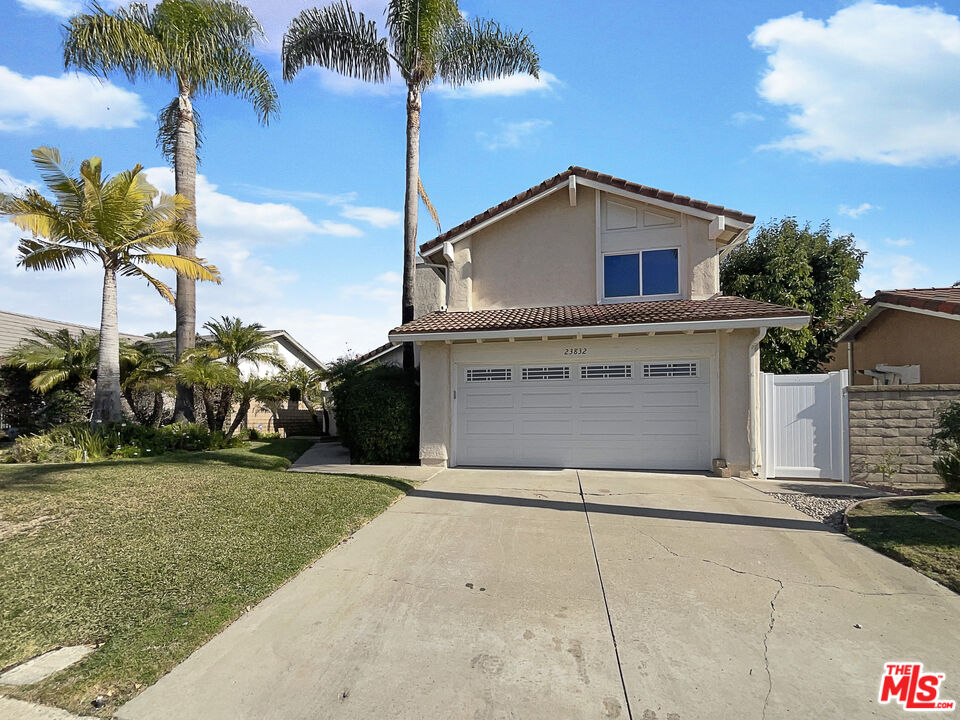 a house with a yard and a garage