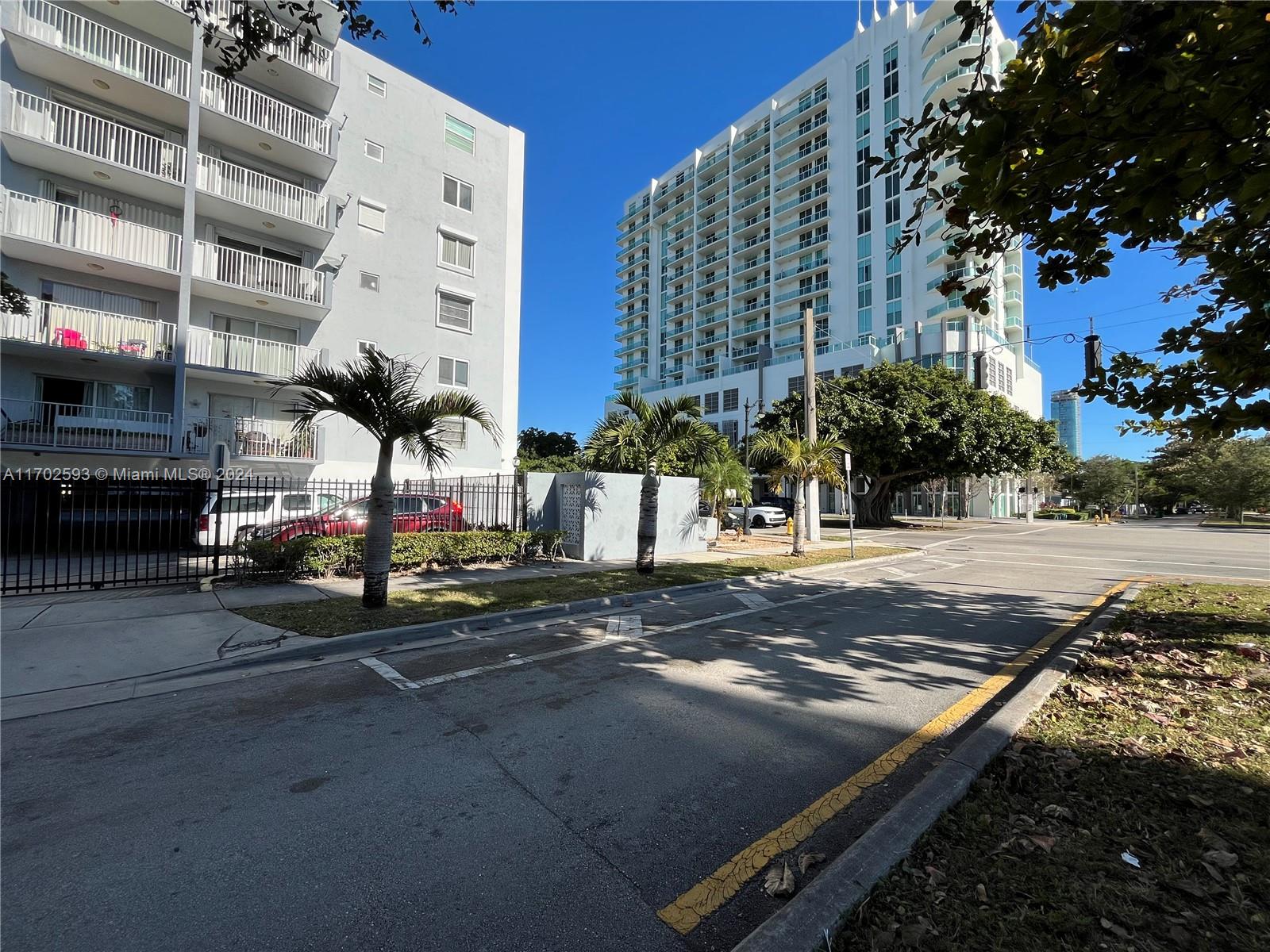 a view of a street with tall buildings