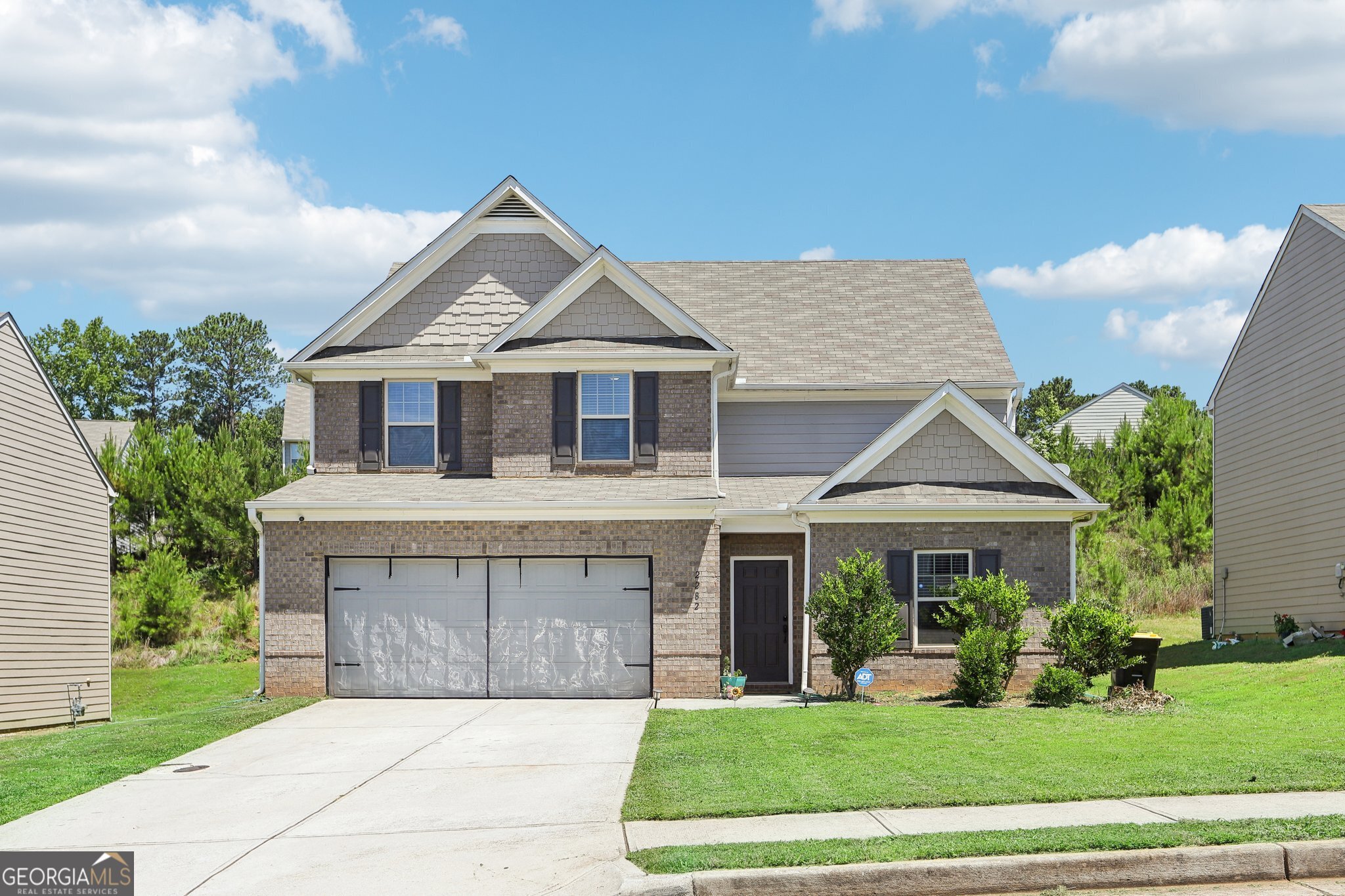 a front view of a house with a yard