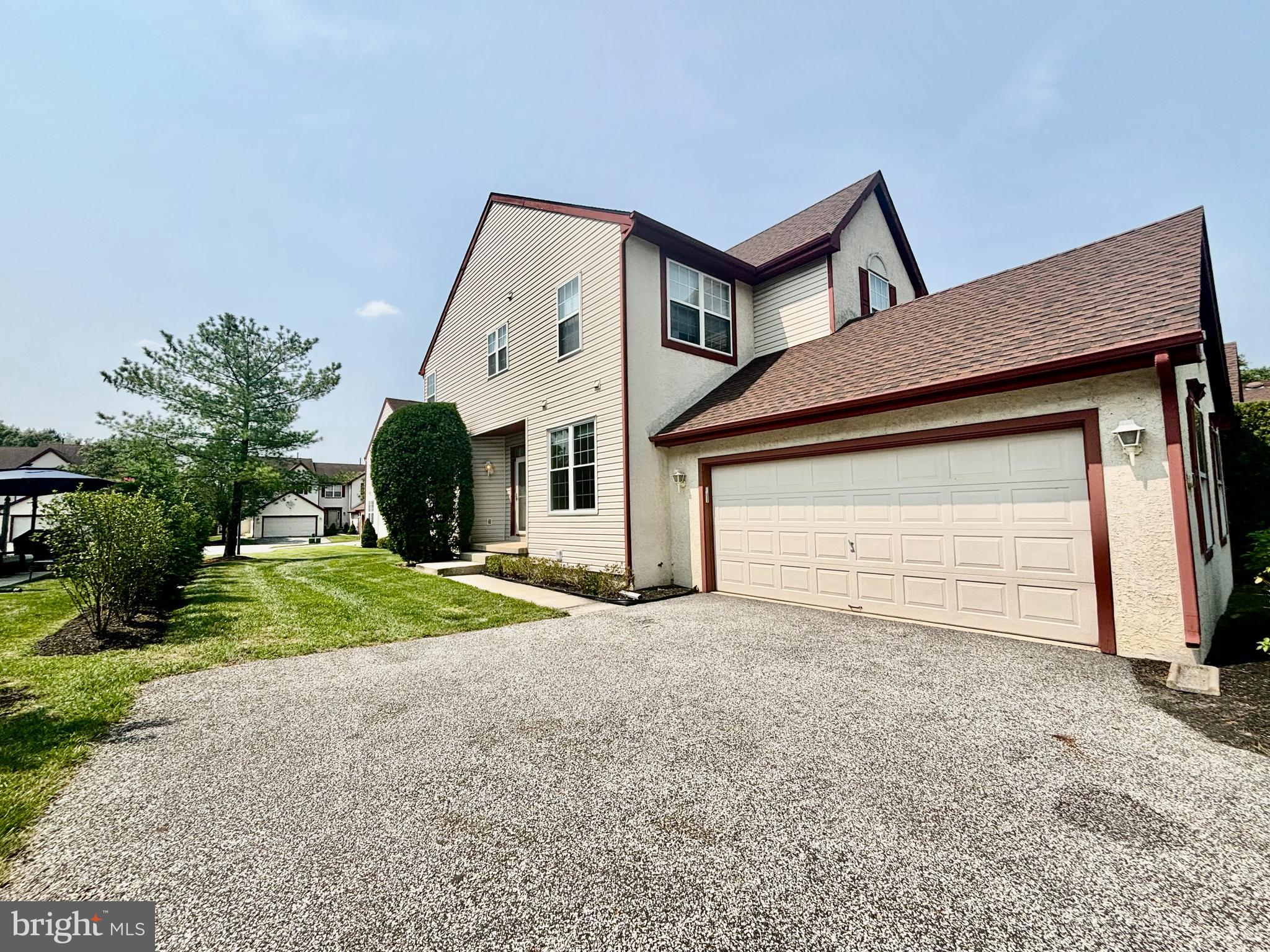 a view of a house with a yard and garage