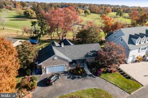 an aerial view of a house with garden space and lake view