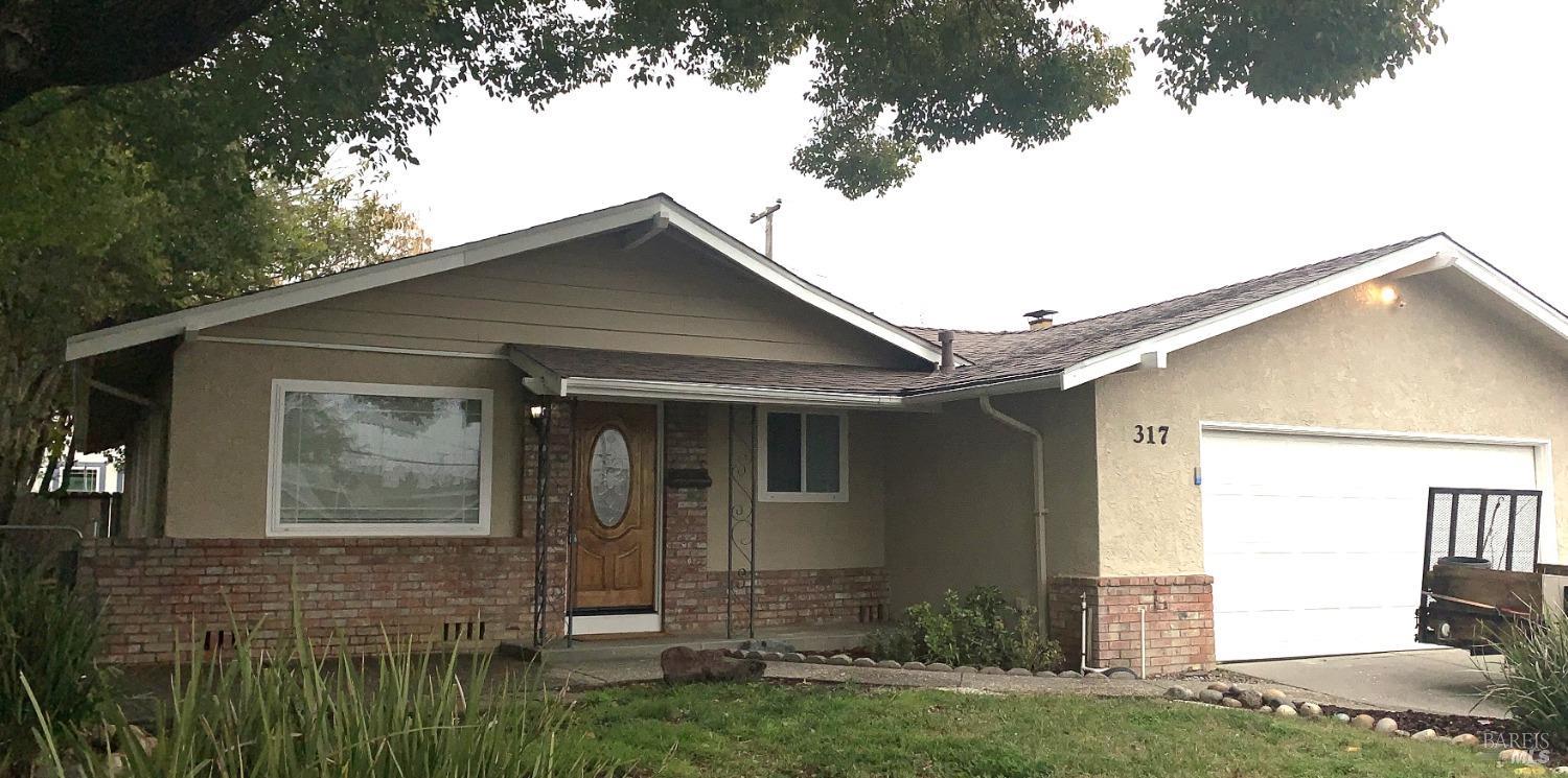 a front view of a house with garden