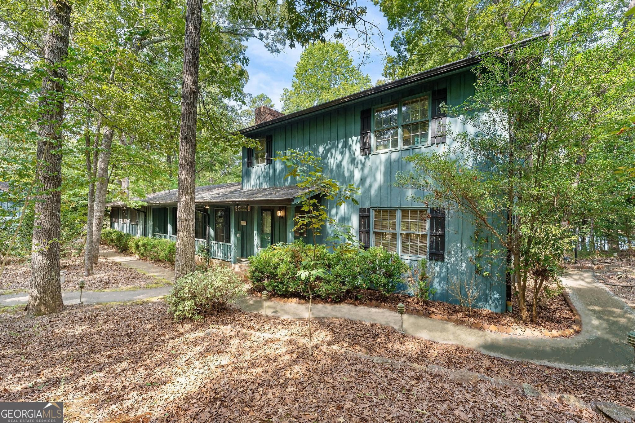 a front view of house with yard and trees around