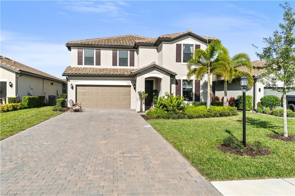 a front view of a house with a yard and garage