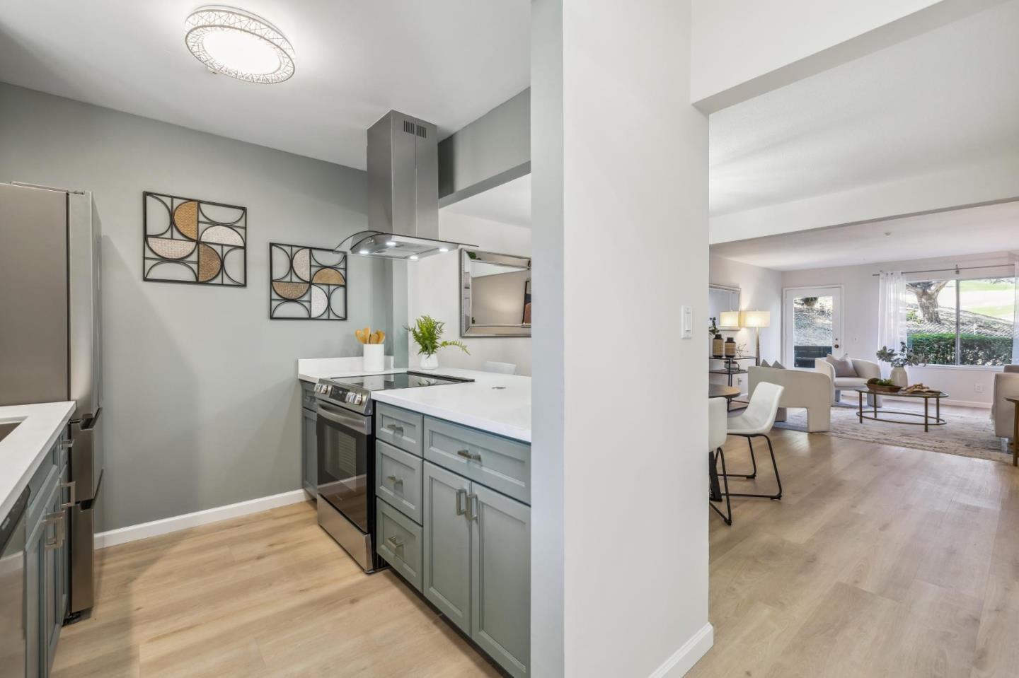 a kitchen with stainless steel appliances granite countertop a refrigerator and stove