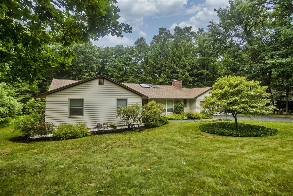 a view of a house with a yard and a garden