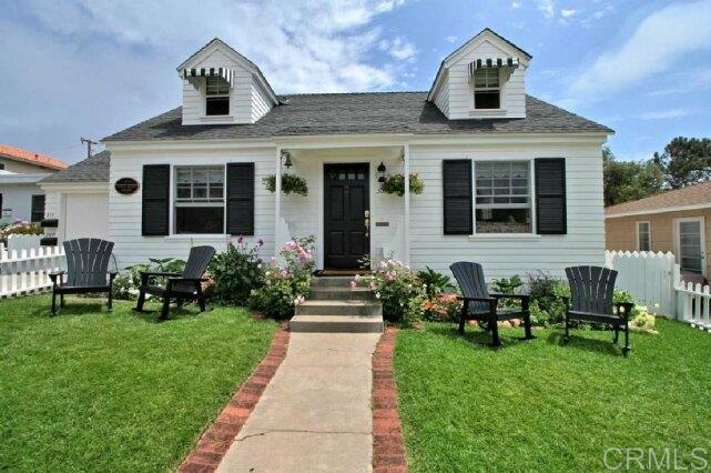 a front view of a house with garden and porch