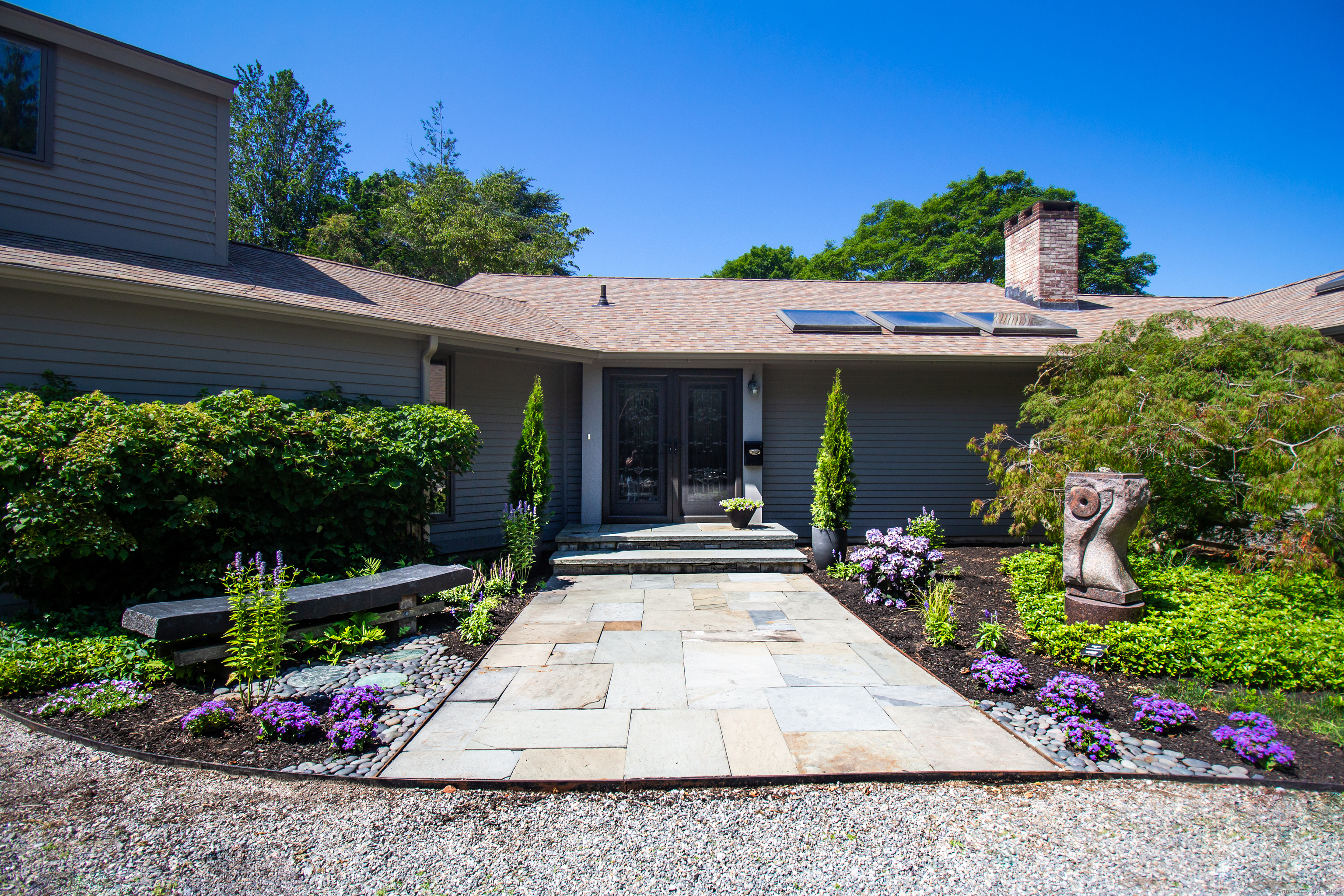 a view of a house with potted plants