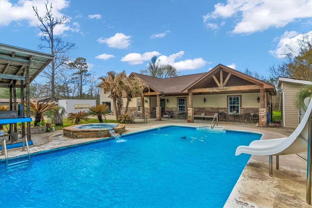 a view of a house with swimming pool and sitting area