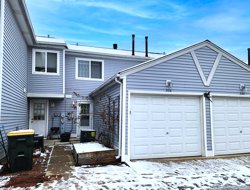 a front view of a house with a garage