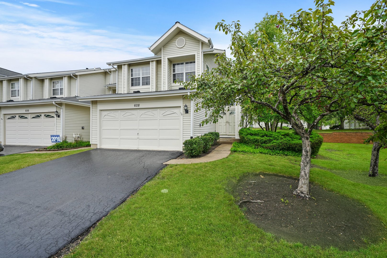 a front view of a house with a yard and garage