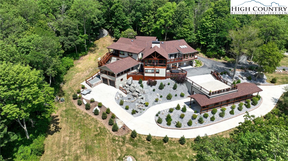 an aerial view of a house with a yard basket ball court and outdoor seating