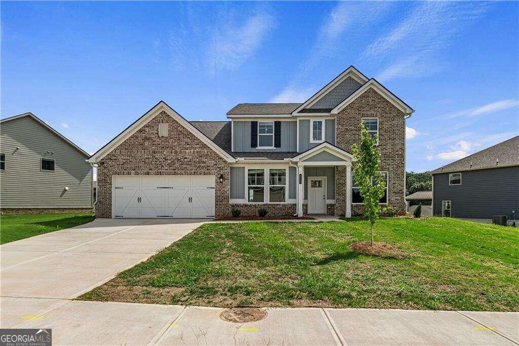 a front view of a house with a yard