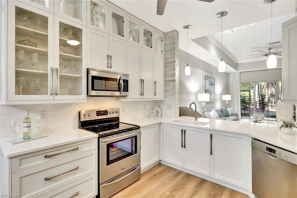 a kitchen with a sink stove and microwave