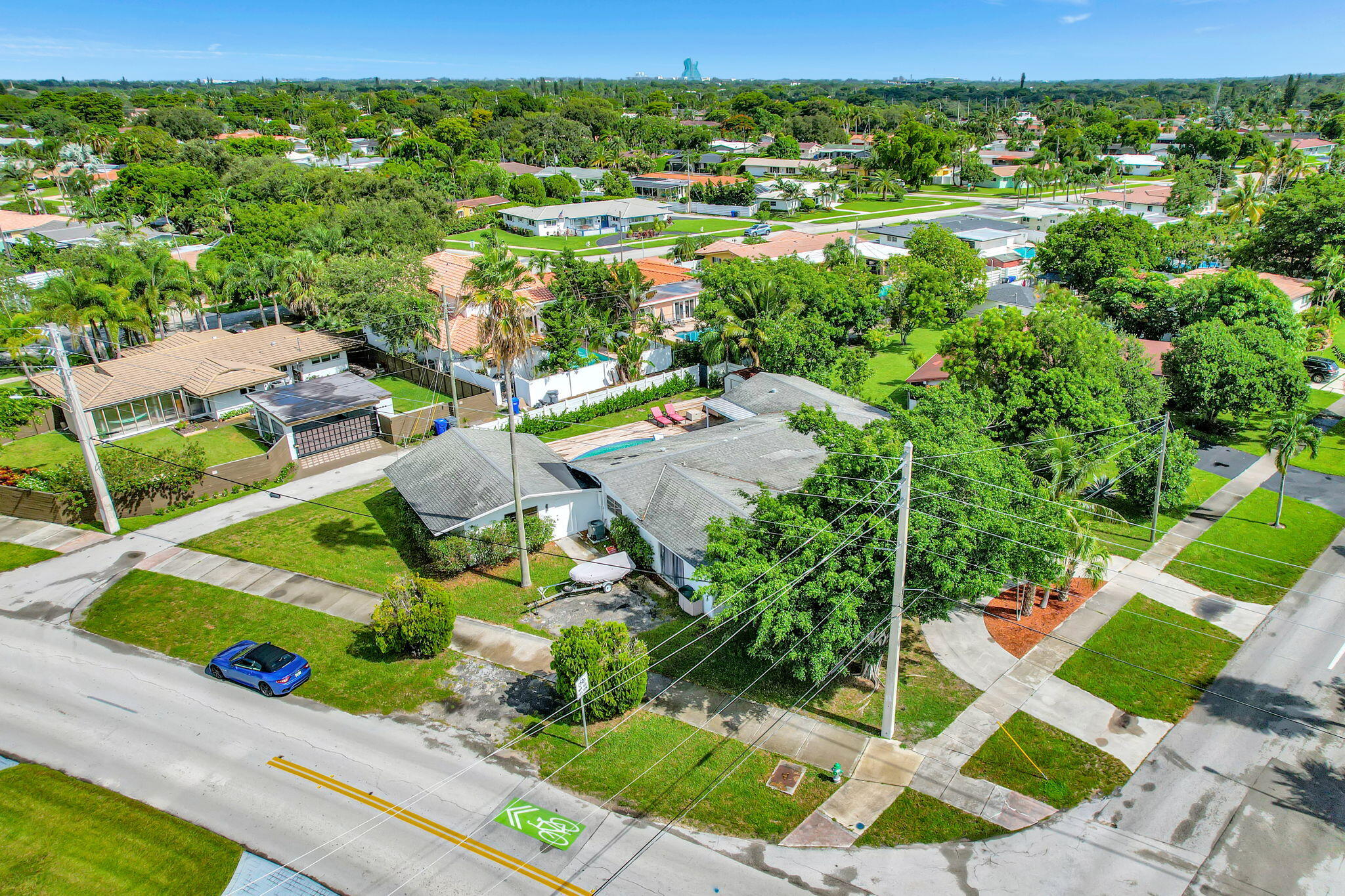 an aerial view of residential houses with outdoor space and street view