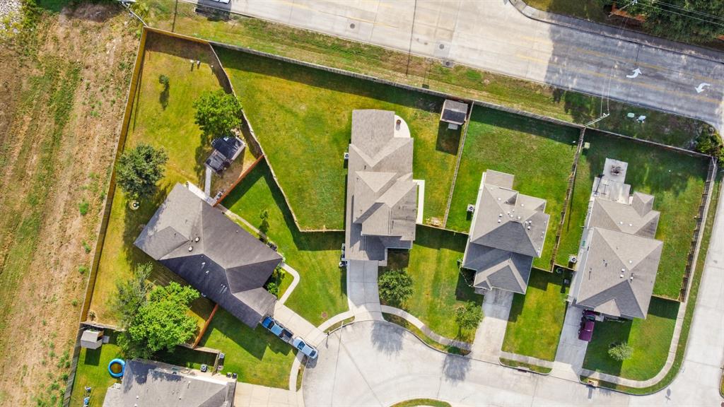 an aerial view of a house with a garden and trees