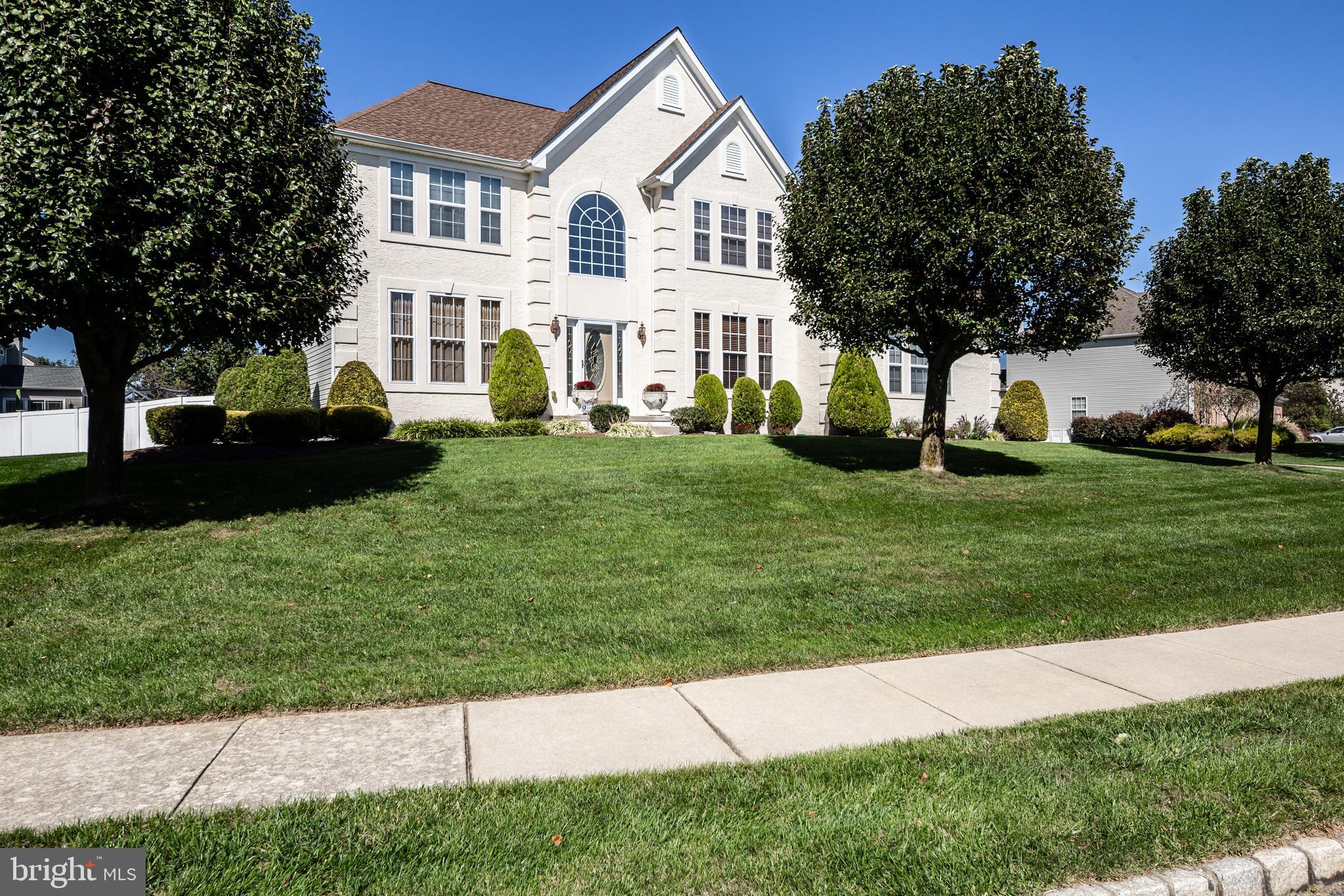 a view of white house with a yard