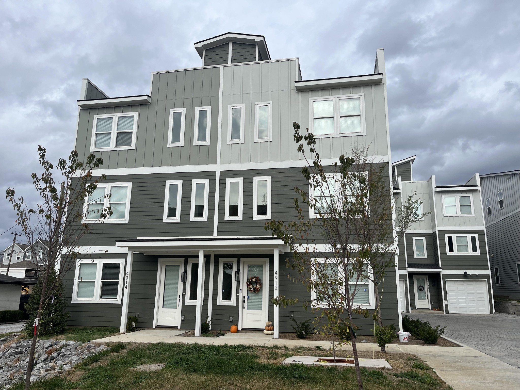 a front view of a residential apartment building with a yard