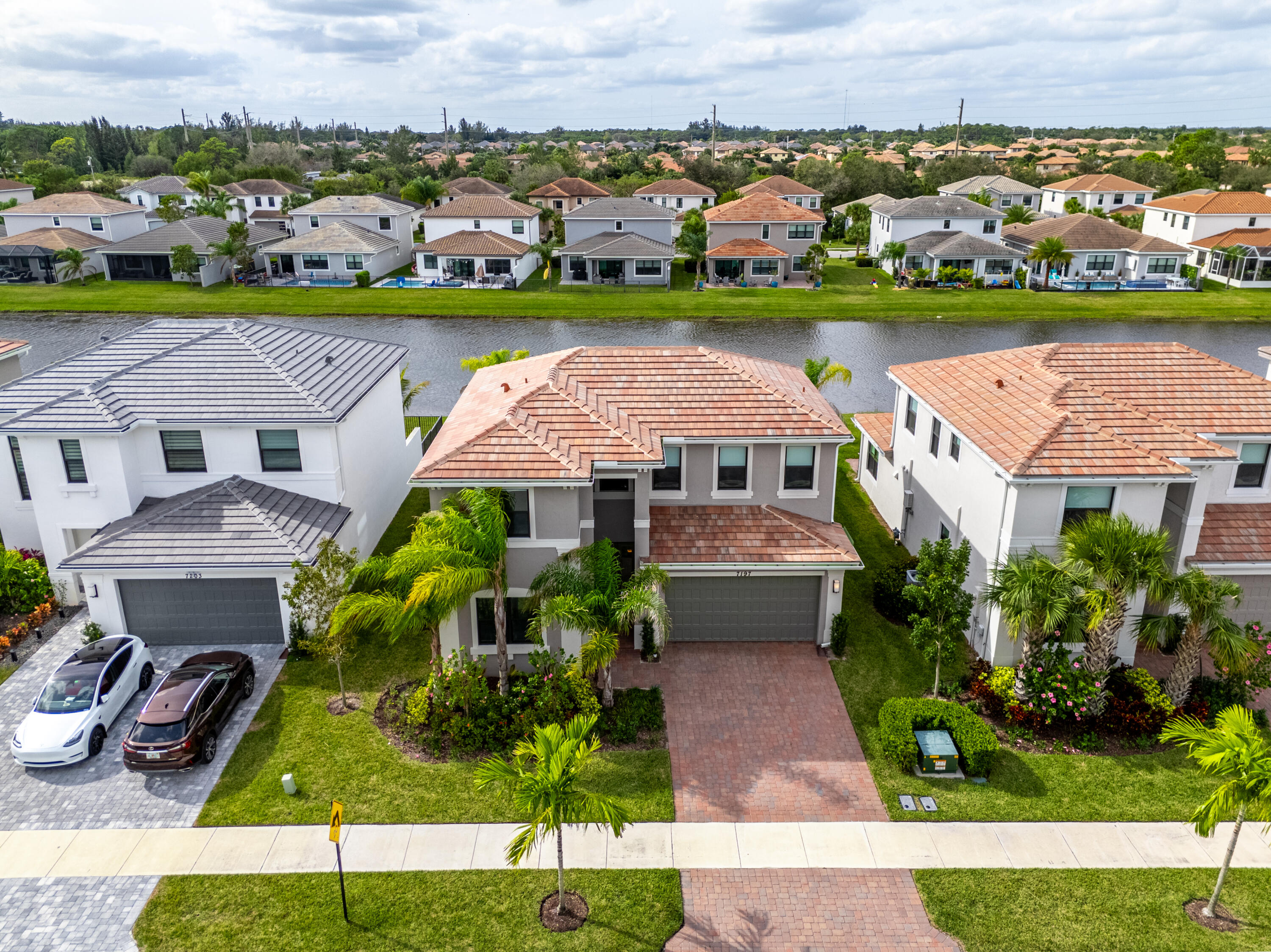 an aerial view of a house with a garden and lake view