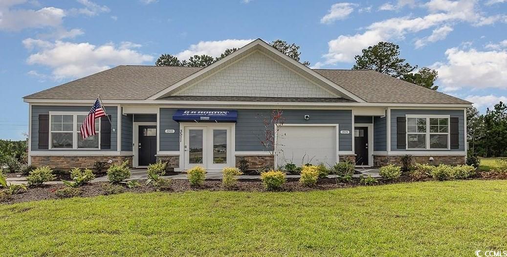 Craftsman-style house with a front lawn and a gara