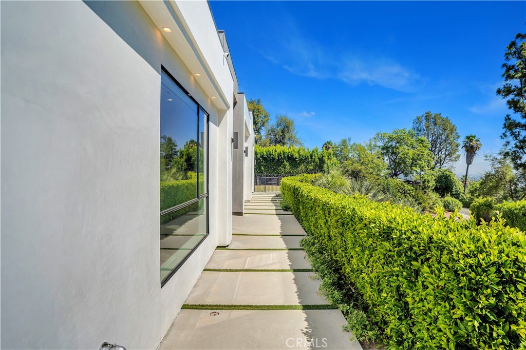 a view of a pathway both side of a house