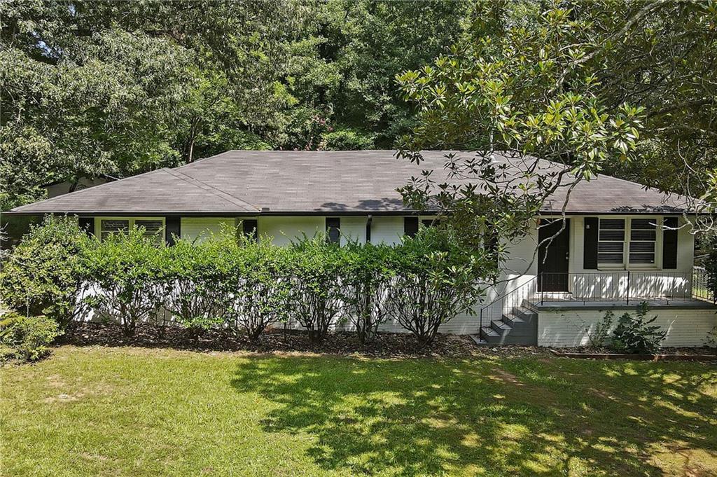 a view of house with garden space and a patio