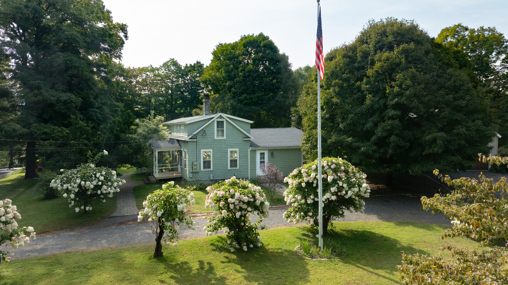 a front view of a house with a yard and swimming pool