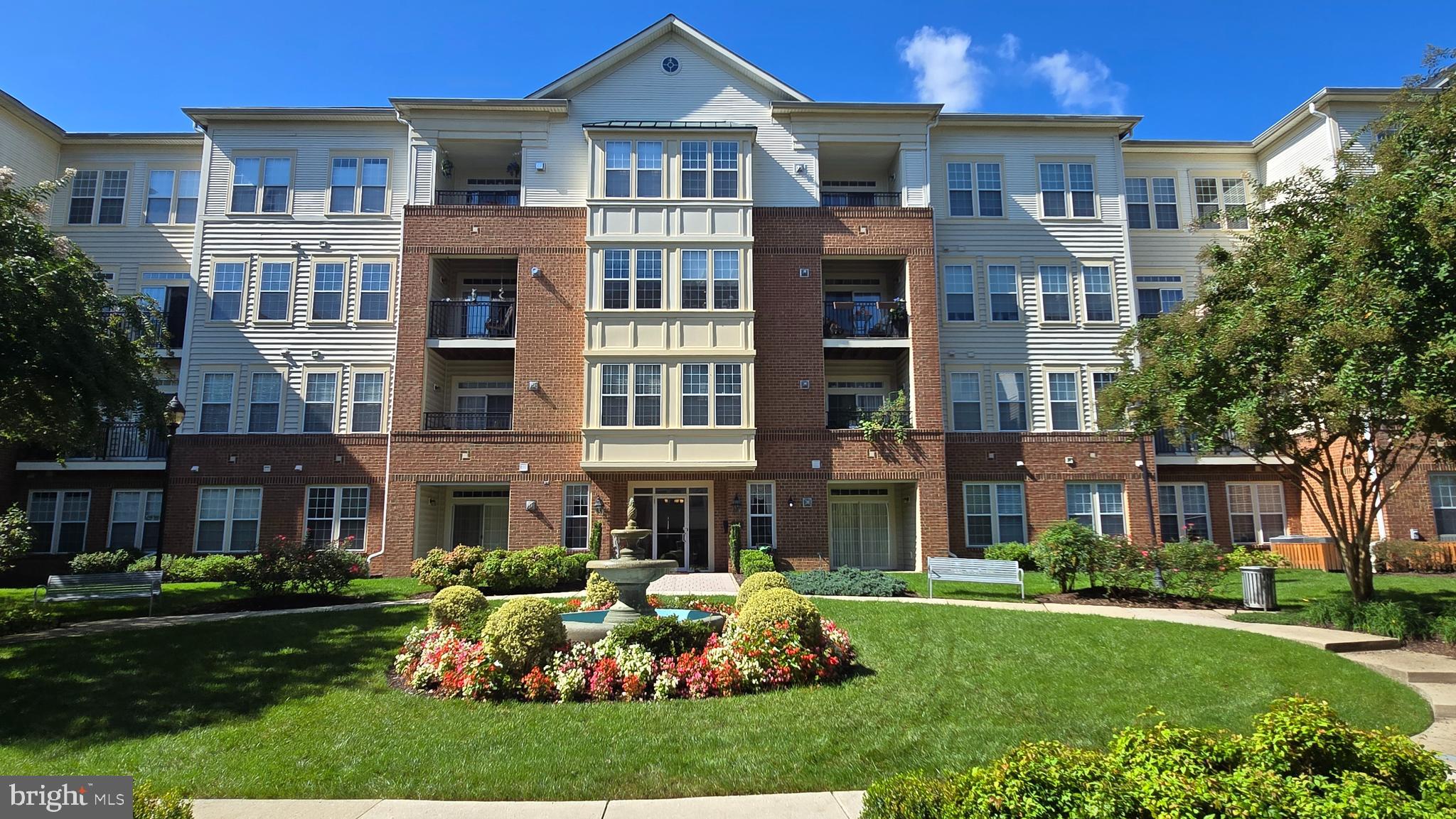 a front view of a residential apartment building with a yard